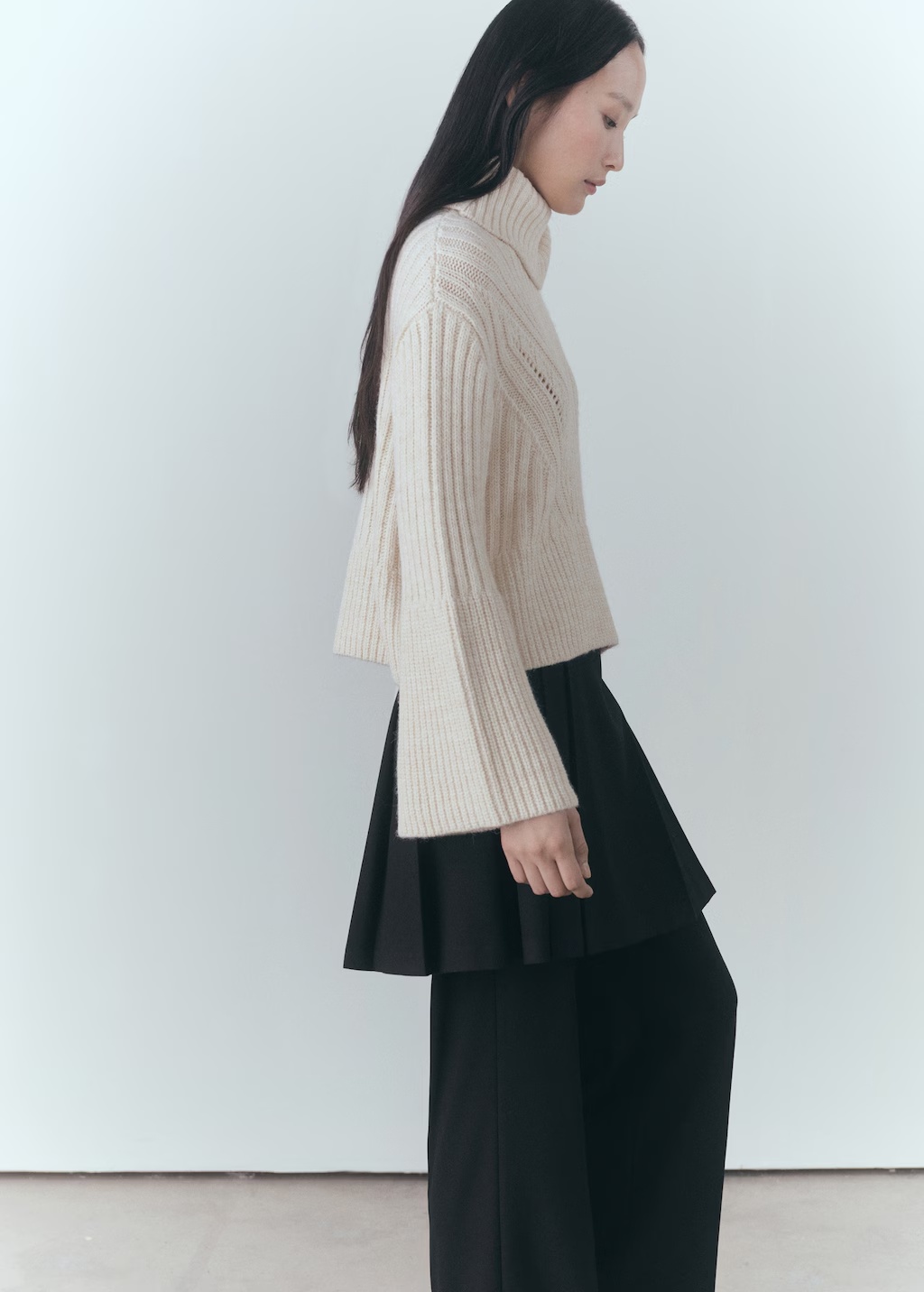 Turtleneck sweater with unstitched detail
