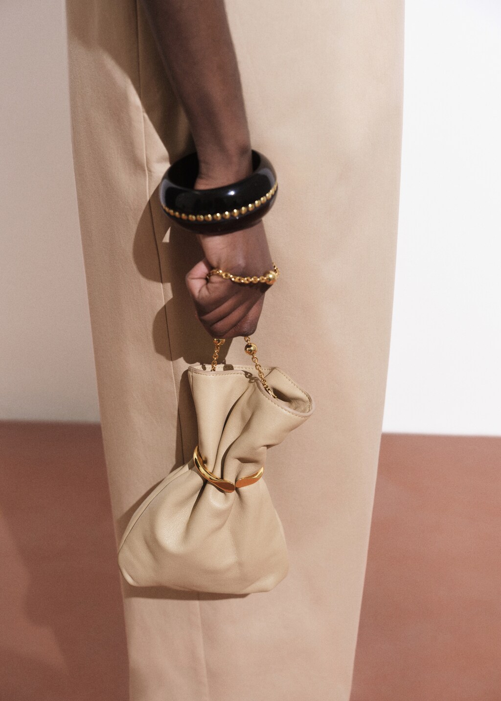 Leather sack-style bag with metallic detail