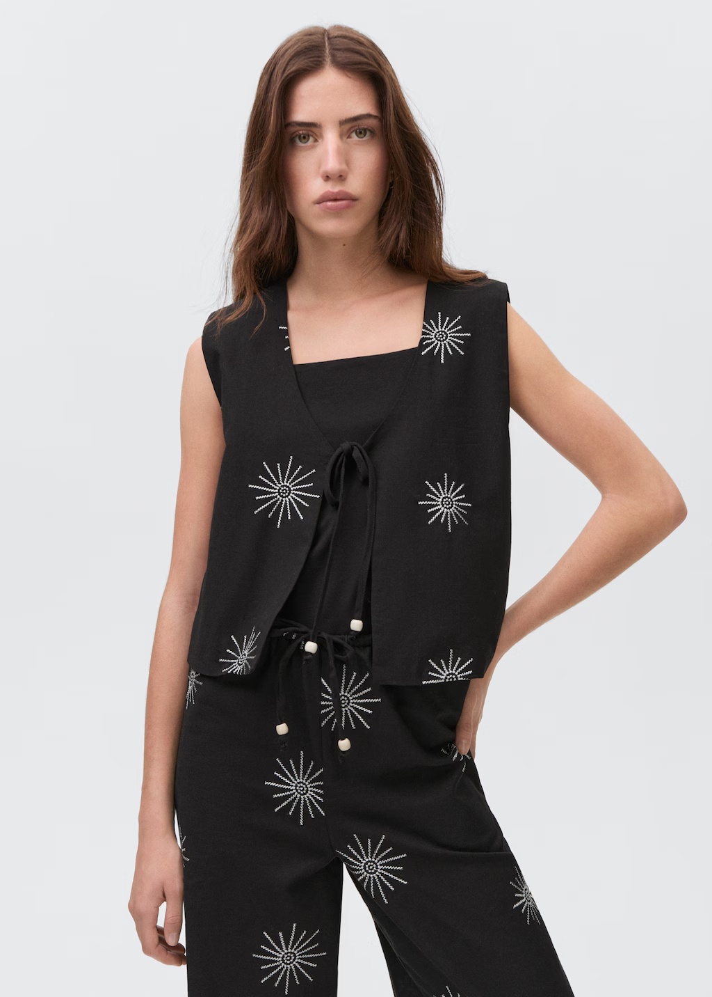 Embroidered top with bow closure