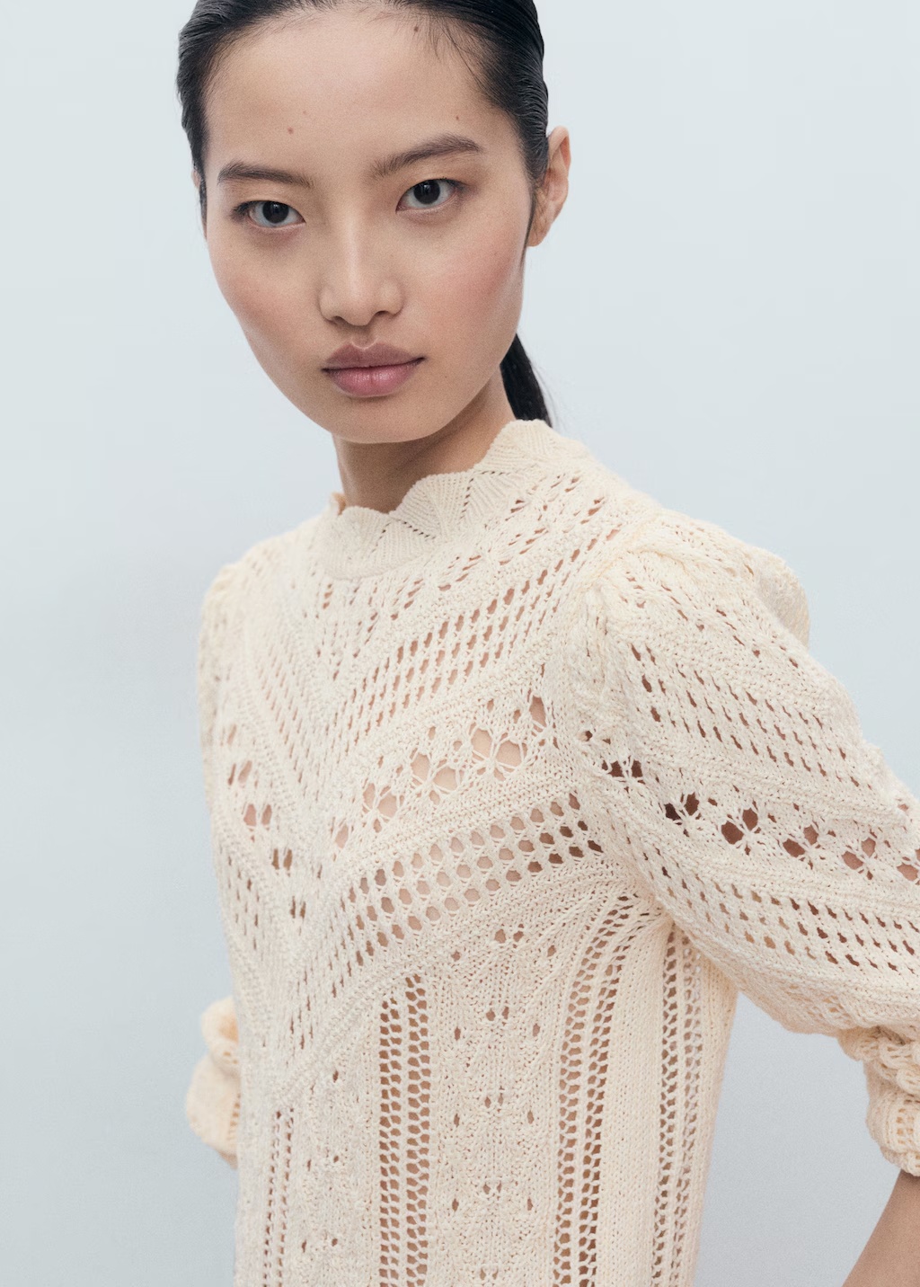 Knitted sweater with openwork details