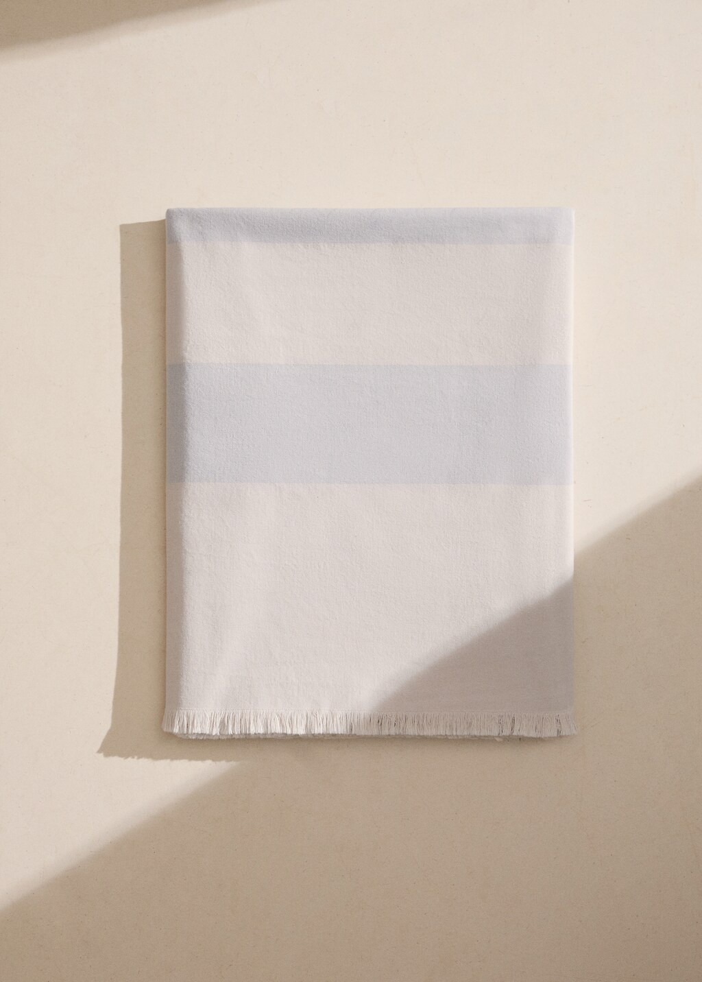 Cotton beach towel with stripes and fringed trim